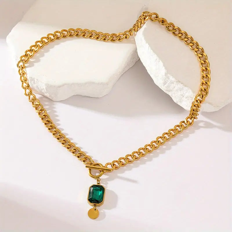 Elegant gold necklace with emerald pendant