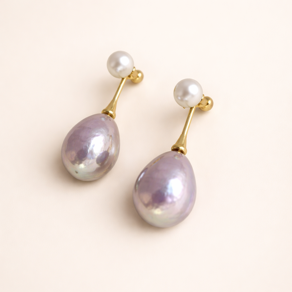 Elegant gold-coloured earrings with lilac pearl