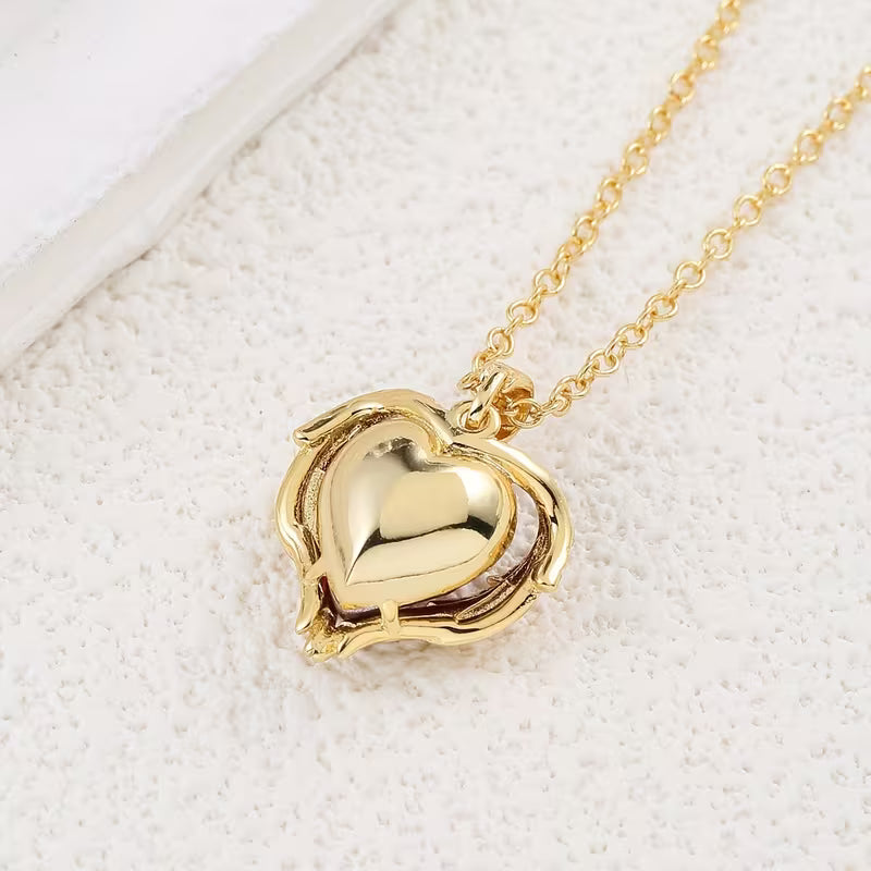 Soft Embrace gold necklace with ruby heart