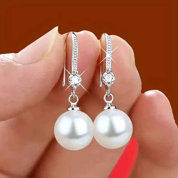 Elegant white gold pearl earrings with cubic zirconia